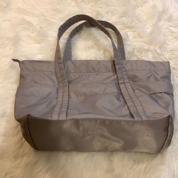 Large gray tote with outside pockets all the way around including one zippered. - Picture 2 of 12